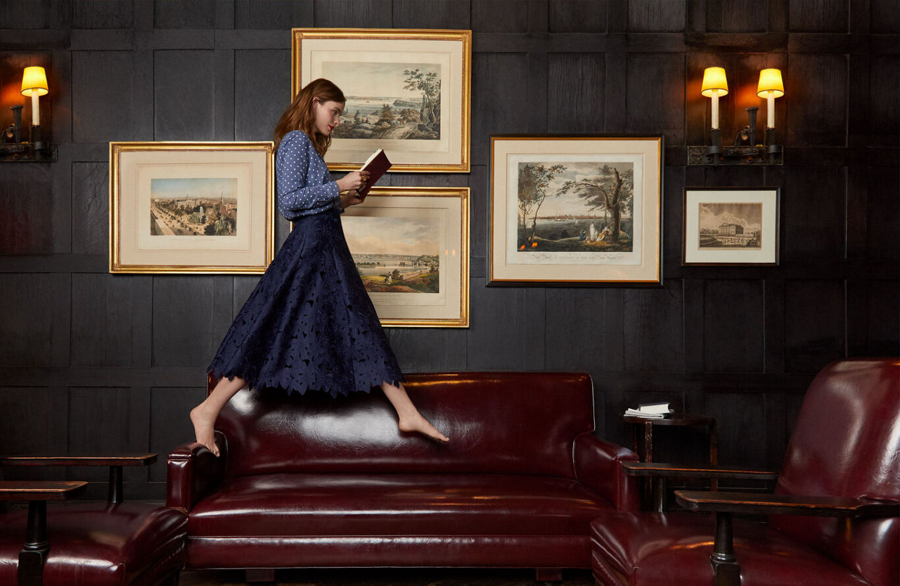 A model walking barefoot on a maroon couch | Blog | Greystar 